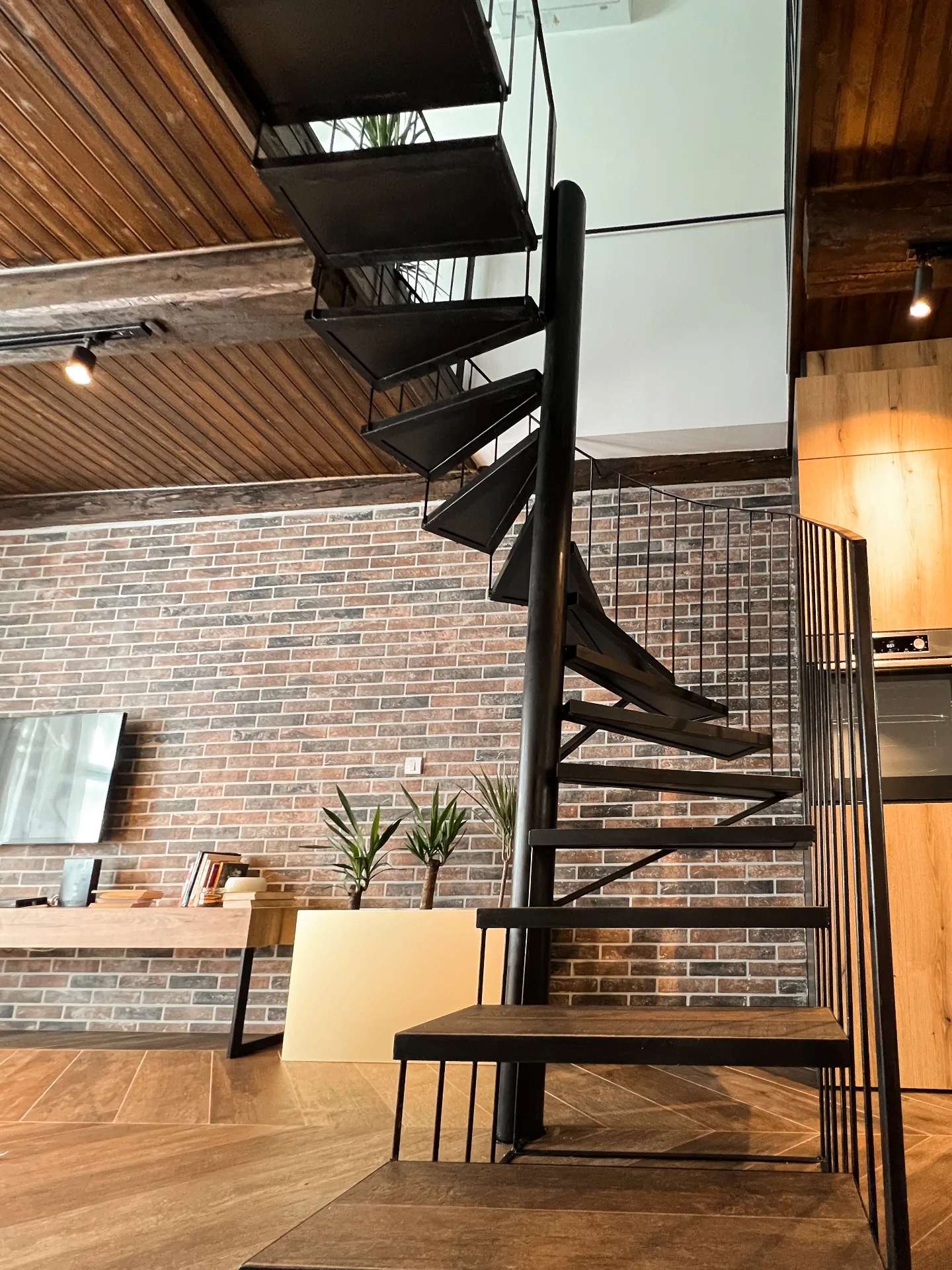 Black spiral staircase connecting the two levels