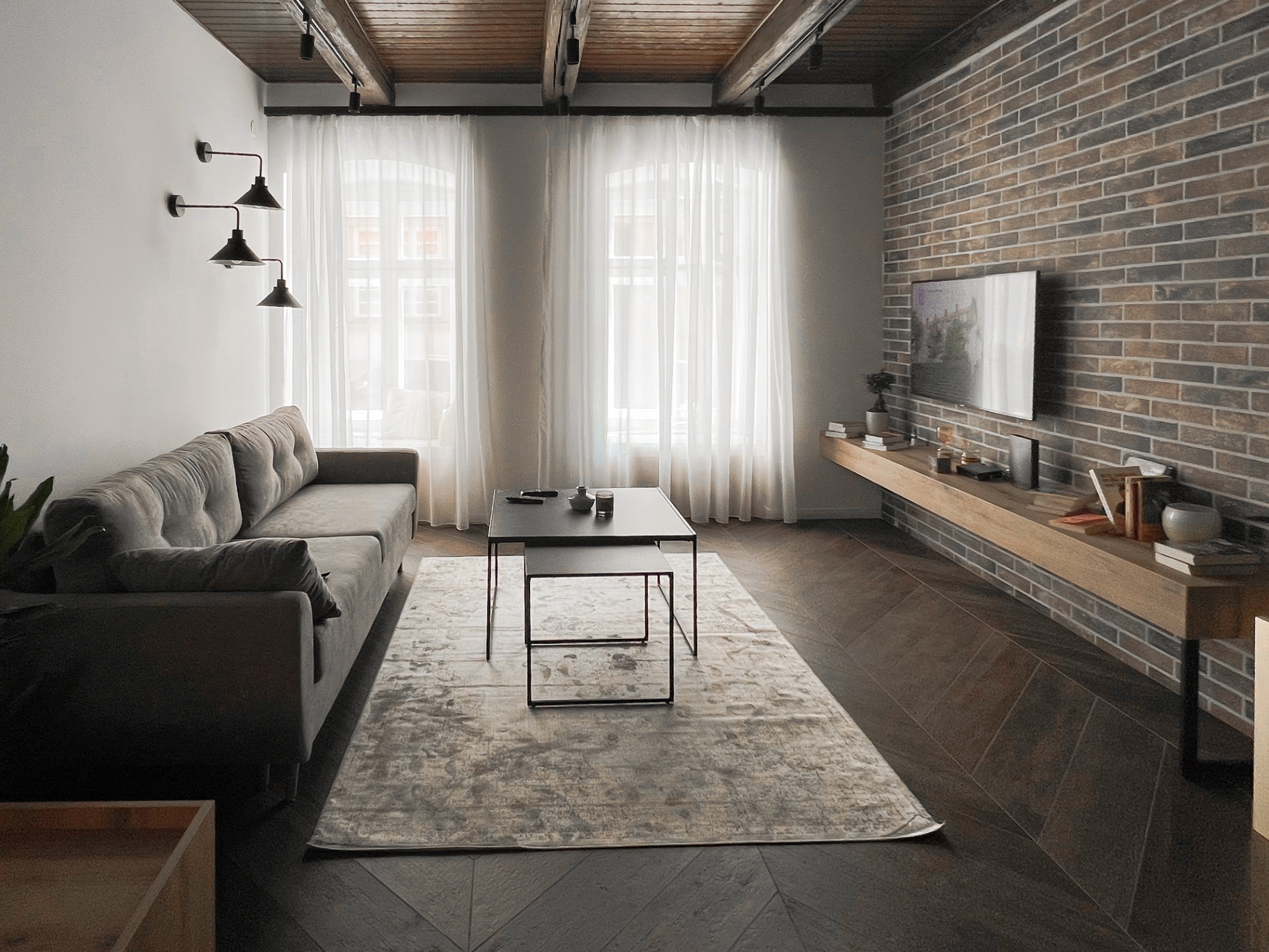 Lower level of the loft with wooden staircase